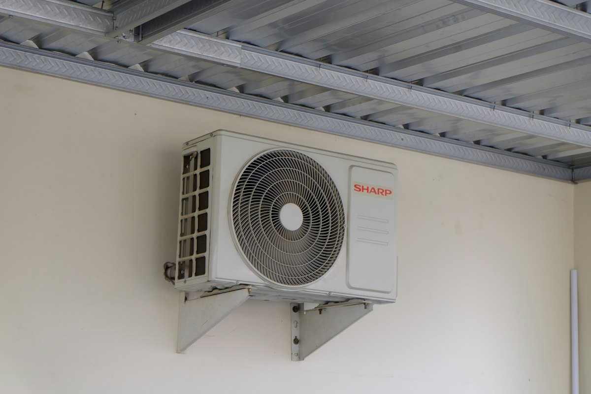 An outdoor air conditioning unit fixed to an exterior wall