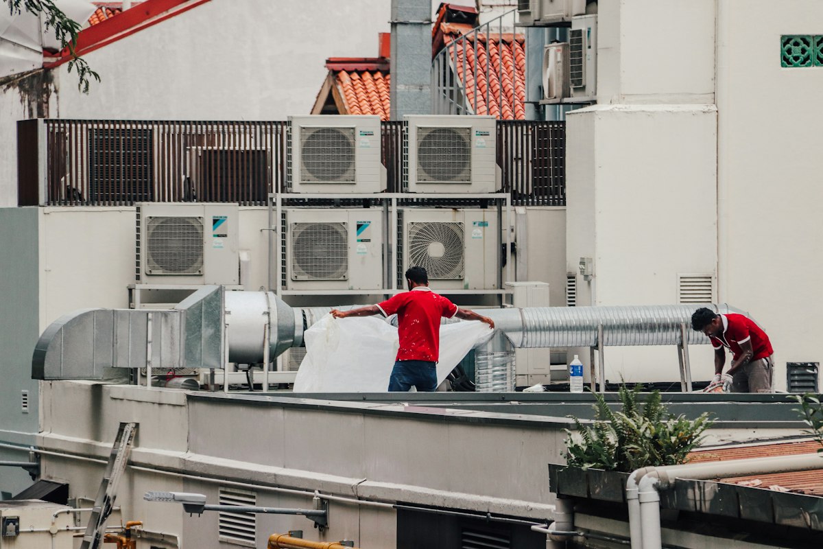 Rows of air conditioning units and pipes in a plant room
