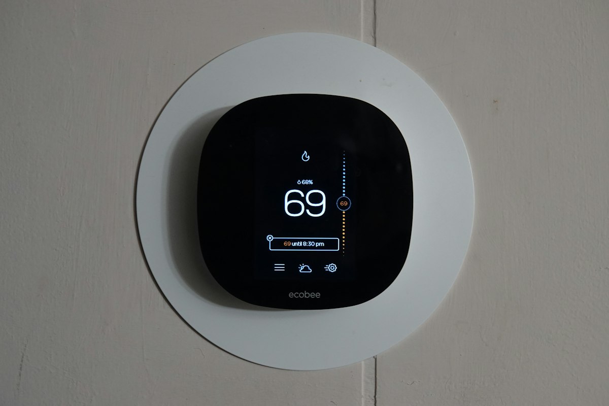 A round smart thermostat with a display, close up